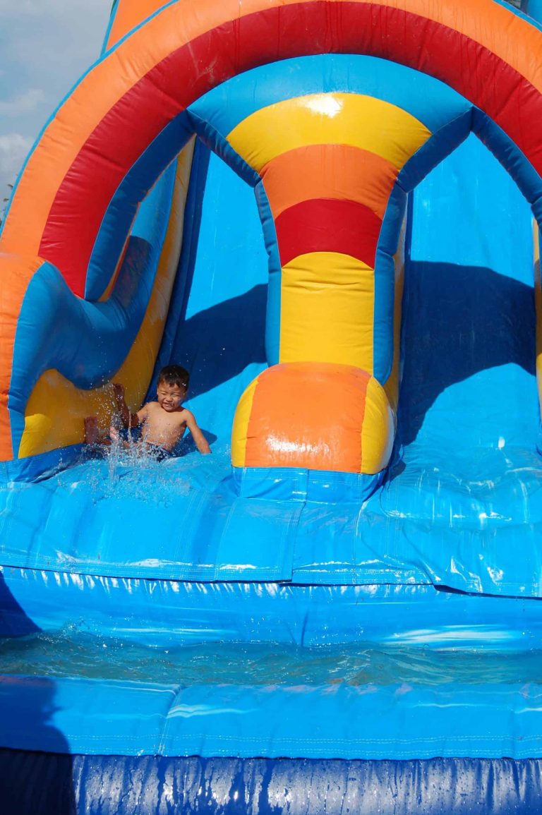 Kids enjoying inflatable water slide rental in Montgomery TX
