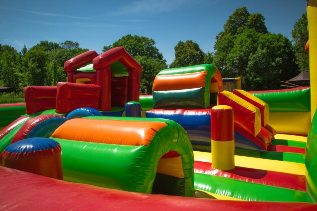 Colorful inflatable obstacle course setup at an outdoor event in Montgomery, TX