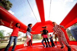 Kids playing inside inflatable obstacle course in Willis TX